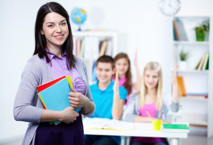 happy-teacher-with-students-background.jpg